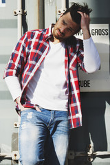 Modern man in shirt and jeans in street