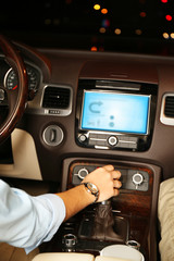 Woman driving his modern car at night in city, close-up