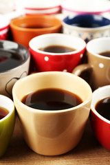 Many cups of coffee on wooden table background, closeup view