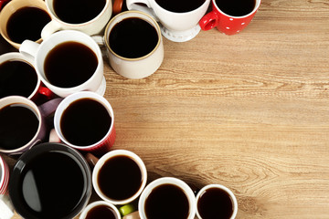 Many cups of coffee on wooden table background, closeup view