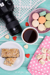 Different sweets and photo camera on table top view