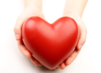 Fototapeta premium Heart in child hands isolated on white