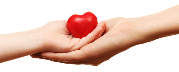 Heart in child and mother hands isolated on white