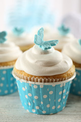 Delicious cupcakes on table on light background