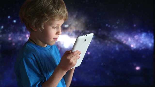 Boy playing with tablet pc.  boy and tablet device in hands
