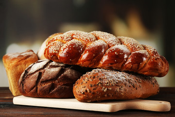Fresh breads with bun on table on bright background