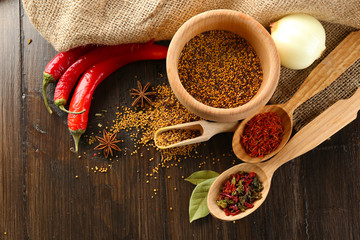 Different kinds of spices on wooden background