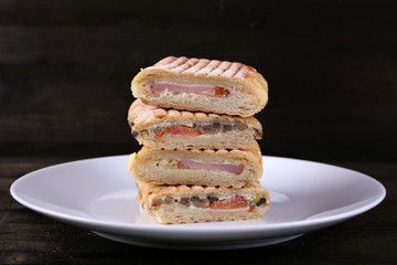 Fresh and tasty sandwiches on plate on wooden background