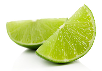 Juicy slices of lime isolated on white