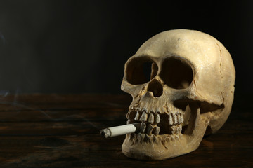 Smoking human scull with cigarette in his mouth