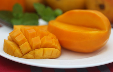 Ripe mangoes with mint leaves