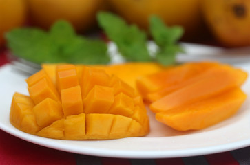Ripe mangoes with mint leaves