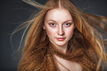 studio portrait of woman with flying hair