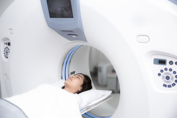 Asian lady sleep on a CT Scan bed