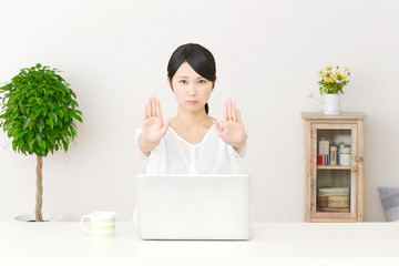 パソコンの前で制止する女性