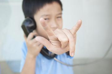 Focus hand of Boy using public phone