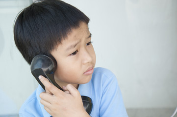 Boy using public phone