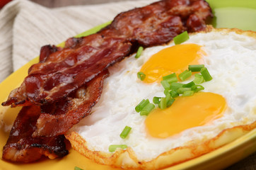 Fototapeta na wymiar Fried eggs with bacon