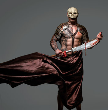 Tattooed medievel fighter in skull mask
