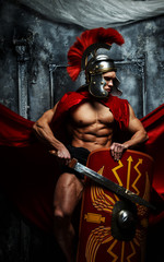 Fototapeta na wymiar Muscular warrior holds shield and sword