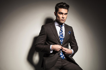 business man closing his button.
