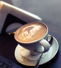 Cup of hot coffee with spume