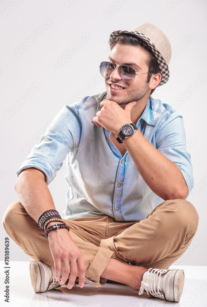 Wall mural Casual man smiling away from the camera