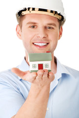 A forewoman holding a model house