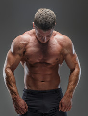 Fototapeta na wymiar Muscular male showing his muscular body