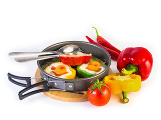 fried eggs on peppers placed on pan