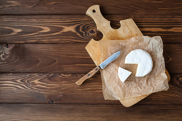 piece of Camembert with knife