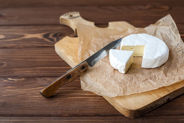 piece of Camembert with knife