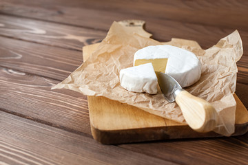 piece of Camembert with knife