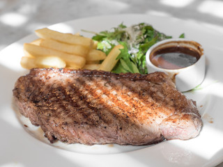 Grilled steak, French fries and vegetables