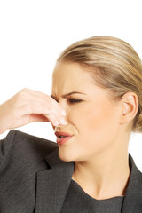 Woman pinching nose because of smell