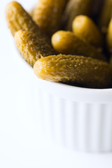 Tiny dill pickles in bowl macro