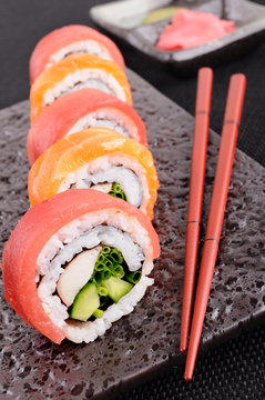 Salmon & tuna sushi roll with chopsticks