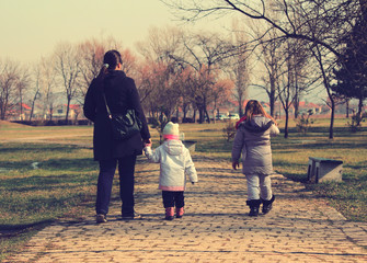 Mother and daughters walking