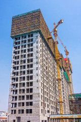 Fototapeta premium Building construction industrial with construction cranes silhou