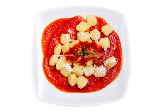 Gnocchi with tomato sauce on white background seen from above