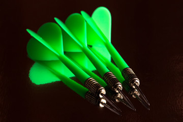 Small group of green darts and it reflection