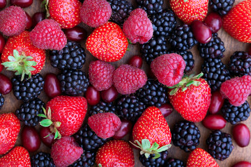 Berries, summer fruit on wooden table.