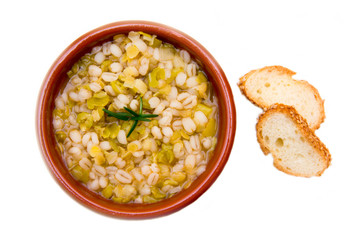 Spelled soup and vegetables on white background top view