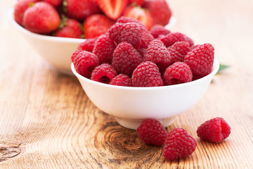 Berries, summer fruit on wooden table.