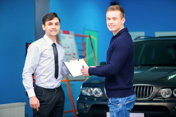 Car owner signing a service order