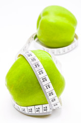 Green apple with measuring tape