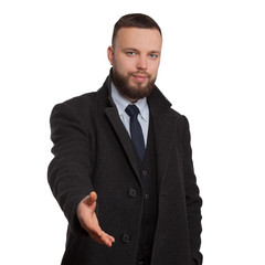 young man with a beard holds out his hand toward