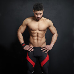 Athletic man on black wall background
