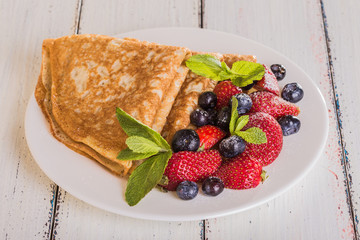 Homemade crepes with berries and fruit