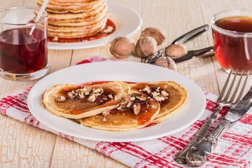 Homemade pancakes with walnuts and strawberry jam